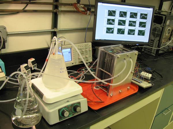 Beaker with liquid and tubes coming out of it feeding into a computer monitor