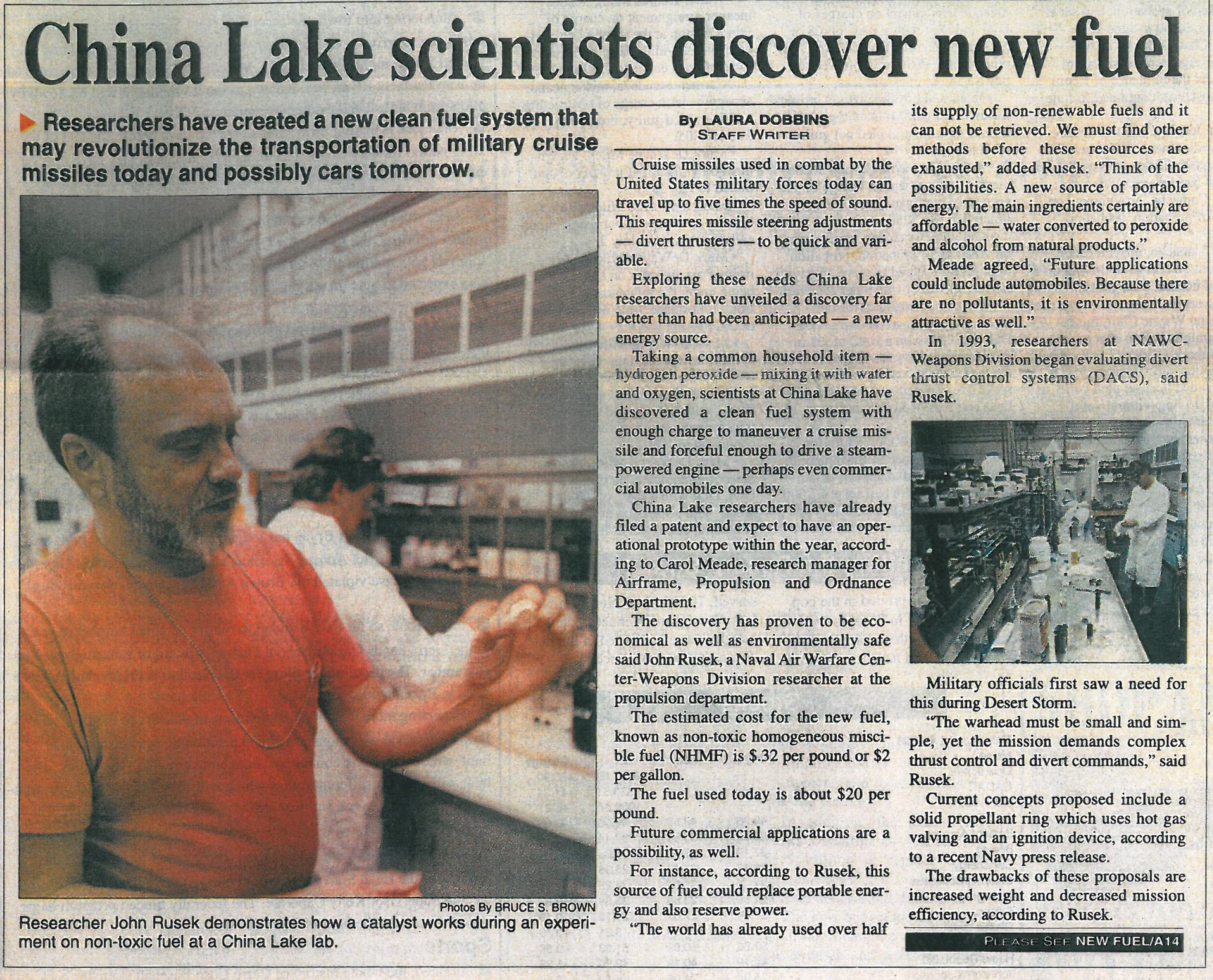 A newspaper article with the headline 'China Lake Scientists Discover New Fuel' with a picture of Dr. John Rusek working in the lab