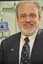 A picture of Mary Rusek, smiling and with glasses